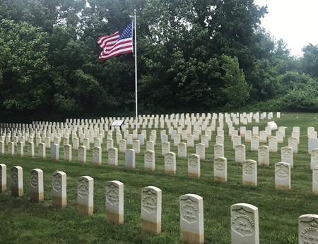 The American flag waves over headstones at the Mount Moriah Cemetery Soldiers' Lot.